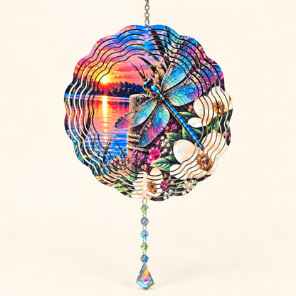 Dragonfly and magnolia sunset wind spinner with example crystal suncatcher on a cream background